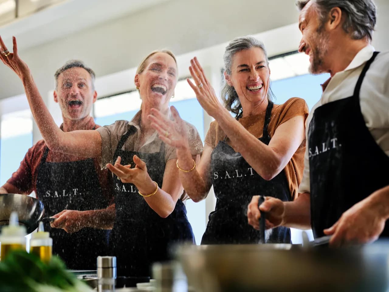 Flour flies and laughter follows as a group of friends share a joyful hands-on S.A.L.T. cooking experience together.