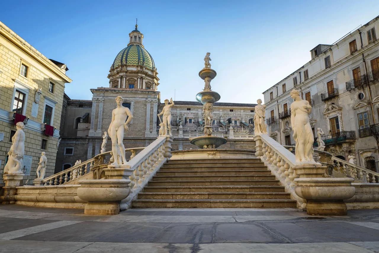 Historic stone cathedral architecture showcasing majestic towering domes framing blue skies.